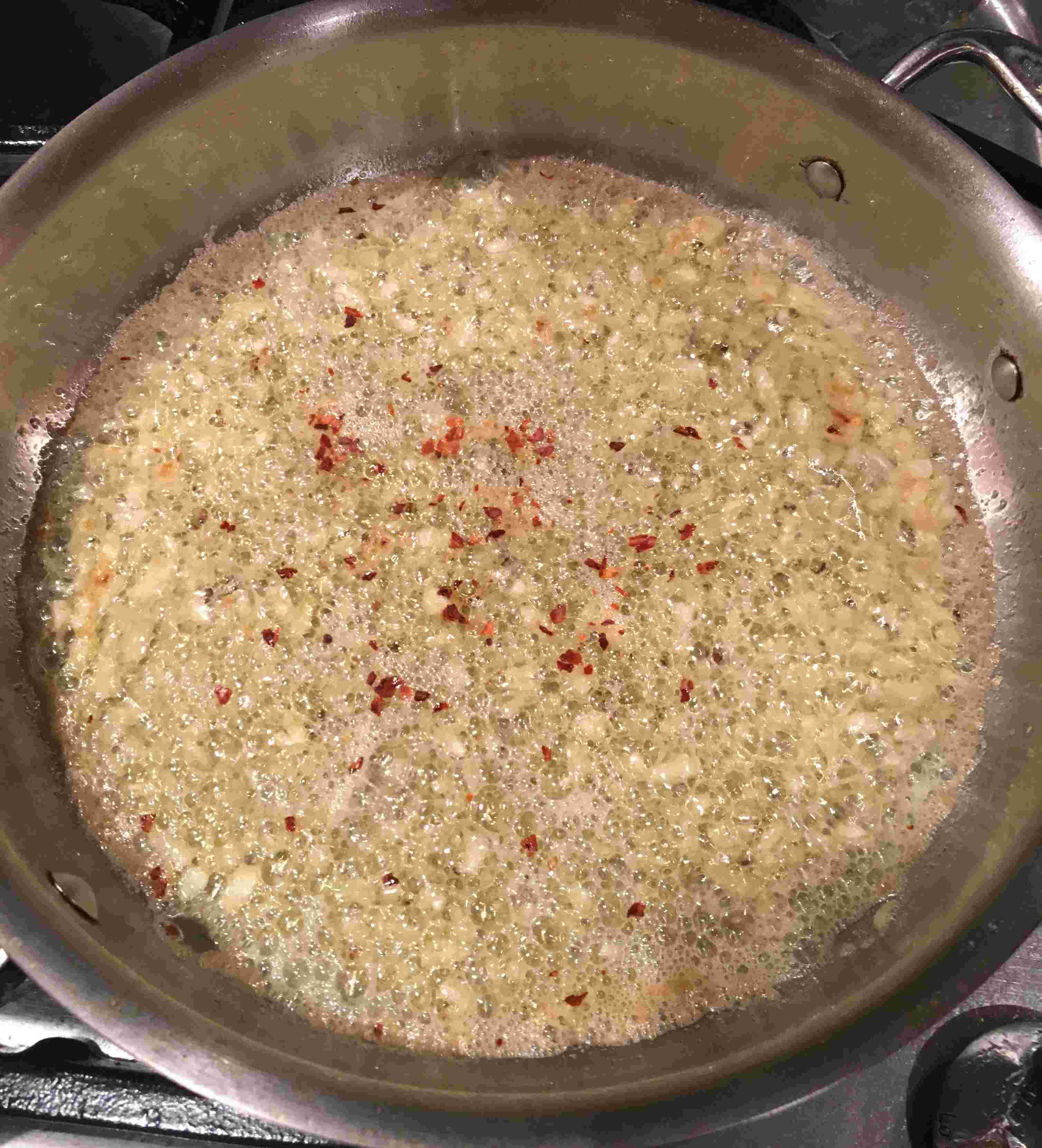 Garlic and red pepper sizzling in olive oil and butter